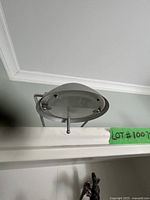 Photo of the top and side view of the bookshelf edge showing the structure and ceiling above.