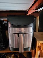 Photo showing front view of Gowise air fryer with black and silver finish. Visible scratches on the stainless steel front surface.