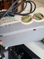 Top view showing control dials, instruction label, and power cord wrapped on heater.