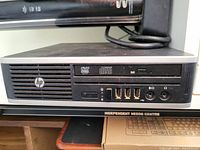 Front side view showing DVD Multi Recorder optical drive, HP logo, 3 USB ports, Ethernet port, audio input/output jacks, and power button.
