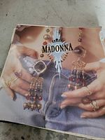 Vinyl record album cover for Madonna's 'Like a Prayer' showing torso with denim shorts and jewelry.