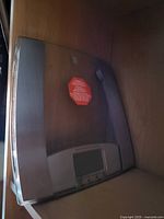 Photo of a digital bathroom scale with wooden finish placed on a wooden floor, front LCD screen visible.