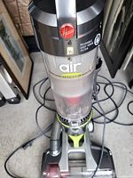 Clear view of Hoover Air upright vacuum with reusable easy rinse filter in dust container section.