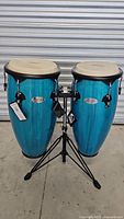 Front view of both conga drums mounted on stand showing color and tags