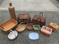 Full arrangement of the baskets, ceramic pots, and blue and white mirror laid out on pavement.