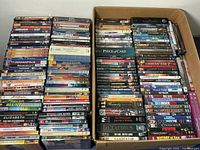 Wide shot of DVDs stacked in two boxes showing a large number of titles including The Untouchables, Elizabeth, and Forrest Gump.