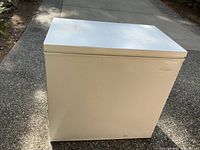 Front view of the white Frigidaire chest freezer showing a flat top surface with some scratches.