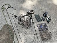 Full view of all items including shepherd's hooks, wire plant hanger basket, bird feeders, and garden animal figurines.