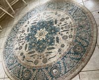Top view of 6-foot round floral medallion area rug in blue, grey, and cream tones.