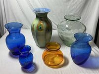 Front view showing all six vases arranged in a group on white backdrop, highlighting colors and shapes