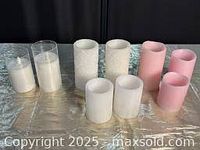 The full set of nine faux candles arranged in two rows, showing a mix of white and pink styles, including some in glass holders and others freestanding.