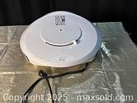 Top closed view of white George Foreman Grill with power cord and clean exterior.