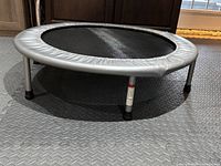 Photo of the assembled mini trampoline from a frontal angle showing frame, legs, and jumping mat.
