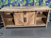 Front view with barn doors centered, showing left and right open shelving compartments