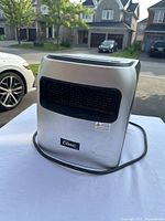Front and side view of the silver Classic electric dehumidifier showing scratches and wear.