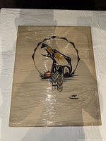 Front view of the wrapped canvas art showing the abstract skull design with neutral, orange and black colors.