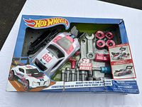 Photo of Hot Wheels race car builder set in original packaging showing race car body, tools, and parts.