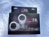 Kink Collection original box for metal handcuffs showing brand, model, and color information