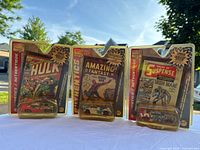 Photo of three Marvel Authentics collectible cars in original packaging featuring Spider-Man, Iron Man, Hulk, and Wolverine.