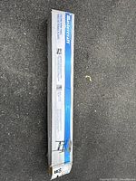 Mastercraft branded box containing folding work table parts, placed on asphalt surface.