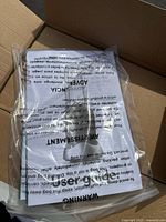Plastic bag with warning and instructions on contents, showing unopened accessories or documentation.