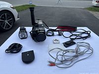 Overview of camcorder and all included accessories on white surface