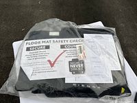 Four-piece set of black carpet floor mats for Toyota Sienna 2021+ in original packaging with safety check instructions visible.