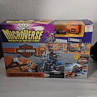 Front view of the boxed Microverse Harley-Davidson Service Center Micro Playset showing branding and key features.