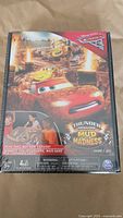 Front of game box showing Disney Cars 3 Thunder Hollow Mud Madness with Lightning McQueen and Cruz Ramirez artwork.