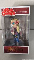Front view of the boxed Luna Lovegood RockCandy vinyl collectible figure showing the packaging and figure details.