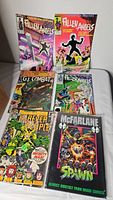 Photo showing eight comic books including Fallen Angels, G.I. Combat, Forever People, and Spawn.