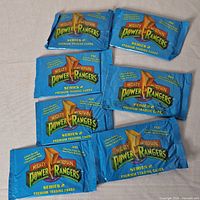 Eight sealed packs of Mighty Morphin Power Rangers Series 2 trading cards laid out, showing front design of blue foil packs with logo and text.
