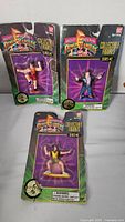 Three Power Rangers collectible figures in original packaging, displayed upright showing clear packaging wear.