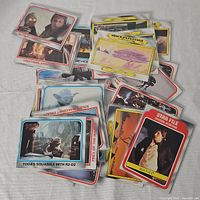Photo showing a scattered lot of Star Wars movie trading cards including characters Yoda, Han Solo, R2-D2, and various scenes.