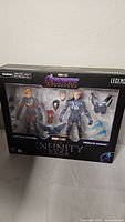 Front view of unopened Marvel Studios Infinity Saga playset box showing Captain Marvel and Rescue Armor figures with accessories inside clear plastic window.