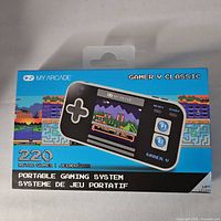 Box of My Arcade Gamer V Classic portable gaming system showing branding, game count, and device image