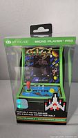 Front view of boxed My Arcade Galaga Micro Player Pro portable arcade showing game screen artwork and controls.