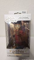 Front of boxed Funko Rock Candy Ron Weasley figure from Harry Potter series, showing figure inside clear plastic window with details of packaging.