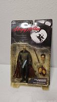 Front view of the Sleepy Hollow Headless Horseman action figure in original packaging, showing the figure, three heads, and axe accessory.