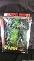 Photo of Spawn Haunt action figure sealed in original packaging showing figure and green flame accessory effects.