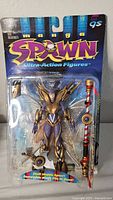 Front view of the Spawn "The Goddess" Ultra Action Figure in sealed packaging showing figure and accessories clearly.