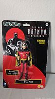 Front view of Robin bendable action figure in original sealed package with Batman Adventures graphics and BendEms branding.