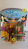 Front view of the packaged action figure showing figure and character card inside blister pack with Star Trek branding and graphics.