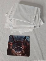 Pile of mostly sealed white wrappers containing vintage Star Wars Trilogy motion cards, with one card opened and displayed showing a colorful scene from the Millennium Falcon cockpit.