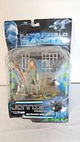 Front view of Battlefield Earth Jonnie action figure in original packaging showing figure, weapon, and restraint collar.