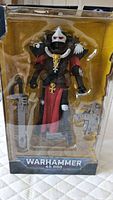 Front view of the Warhammer 40,000 Adepta Sororitas Battle Sister action figure in original packaging showing figure and accessories such as chainsaw sword and firearm.
