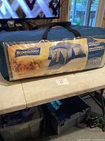 Broadstone tent sealed in original blue carry bag with label displaying branding and tent image