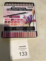 Front view of the 18 coloured pencils set packaging showing color palette and flower illustration.