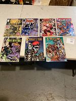 Seven comic books displayed on a table, includes Nightbreed, Shadowhawk, Breakthrgh, Wildcats, Sci-Tech, and two Knightstrike issues.