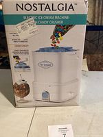 Front side of the box showing Nostalgia electric ice cream machine with candy crusher, making ice cream in 15 minutes with 3 quart capacity (note seller data said 2 quart).